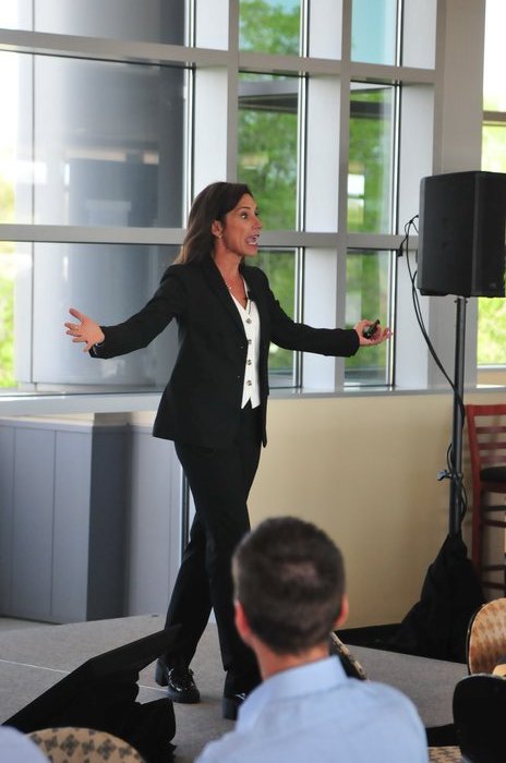 Jennifer Merrell speaking energetically on stage